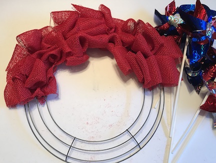 Here's a great tip- each section of the metal wreath ring, takes one roll of ribbon from the dollar store. So since I did 3 sections of the wreath in burlap, I needed 3 rolls of ribbon. 