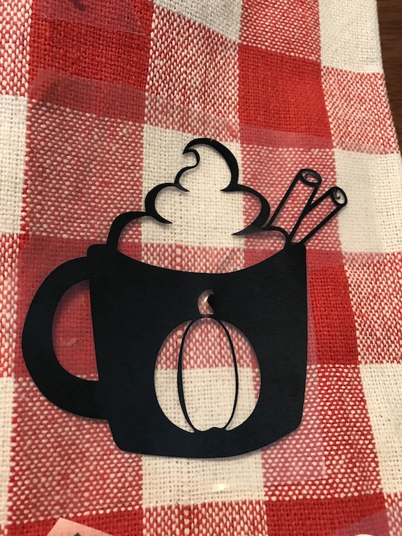 Coffee cup on fall kitchen towel