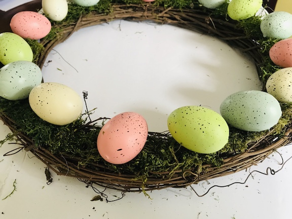 hot glue the Easter eggs on top of the moss all around the wreath
