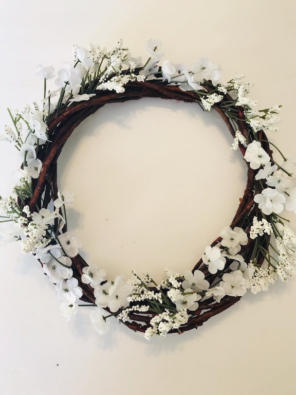 Adding white florals to the Dollar Tree Easter egg wreath 