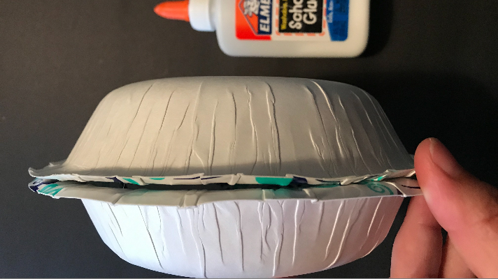 glue the paper bowls together for a double sided pumpkin craft for fall and halloween for kids