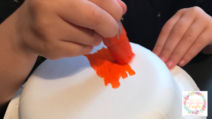 Use paint markers to color the paper bowl pumpkin for a fall or halloween pumpkin craft