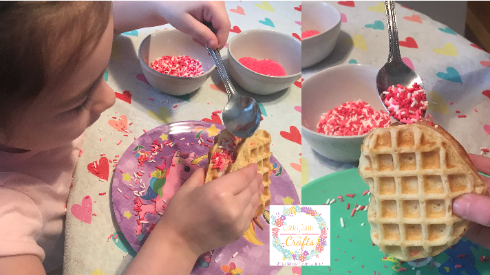 Adding sprinkles to the Heart Shaped Waffle Ice Cream Sandwiches for Valentines Treat