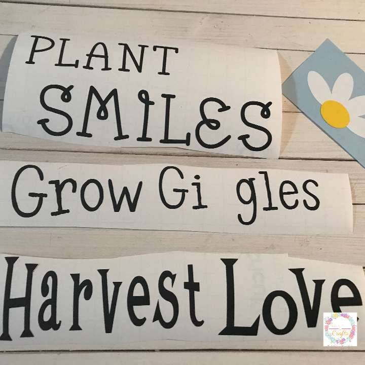 Weed the Cricut Vinyl Designs to add to the wood signs