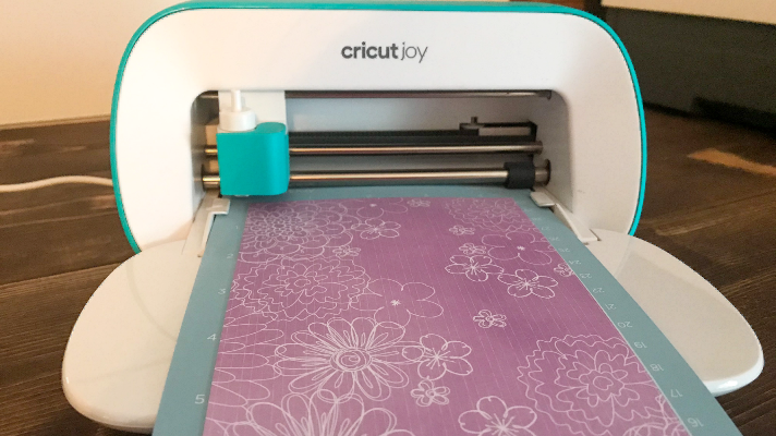 Cricut Joy cutting the Cricut Adhesive backed paper to make a DIY notebook cover with Cricut 