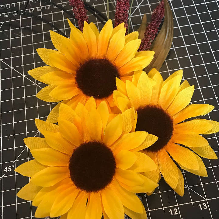 Glueing on the sunflowers to the Dollar Tree Wreath 
