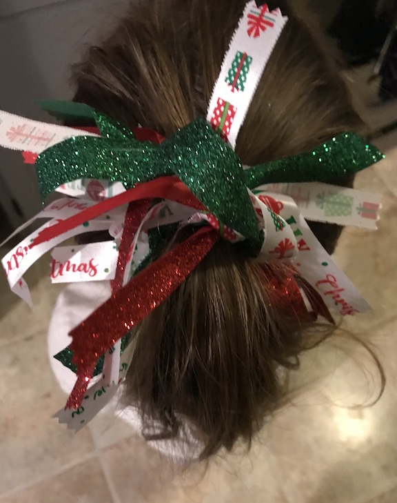 My daughter loves to wear her hair in a ponytail. Plain black hair ties/elastic are so boring. Learn how to make a cute DIY glittery Christmas ponytail holder with ribbon. #Christmas #Ponytail #DollarTree 
