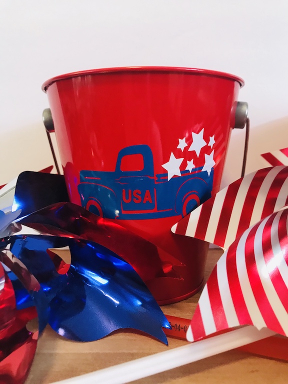 Celebrate the 4th of July with these fun 4th of July Party decorations. These buckets are perfect for a party, the table, house, or as cheap centerpieces. Decorate them with your Cricut and celebrate America with red, white, and blue. Great for any patriotic holiday. #CricutMade #4thofJuly ##4thofJulydecoration #Party #Centerpieces #DIY 