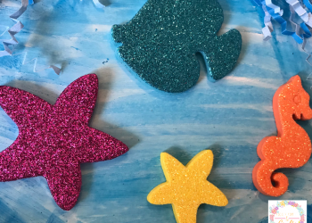 Adding sea creature foam stickers to the fun paper plate ocean craft for kids