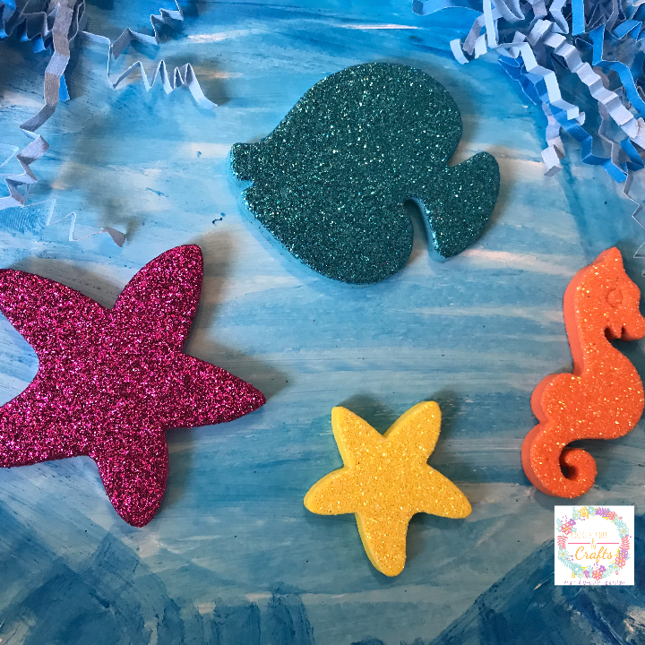 Adding sea creature foam stickers to the fun paper plate ocean craft for kids 