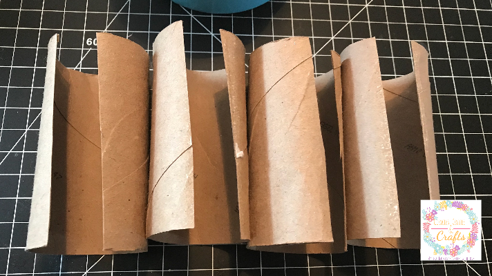 Cutting the toilet paper rolls long ways to make the techno bracelets