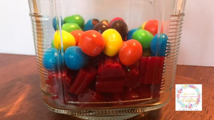 Layering the candy in the jar for Fathers Day DIY Gift 