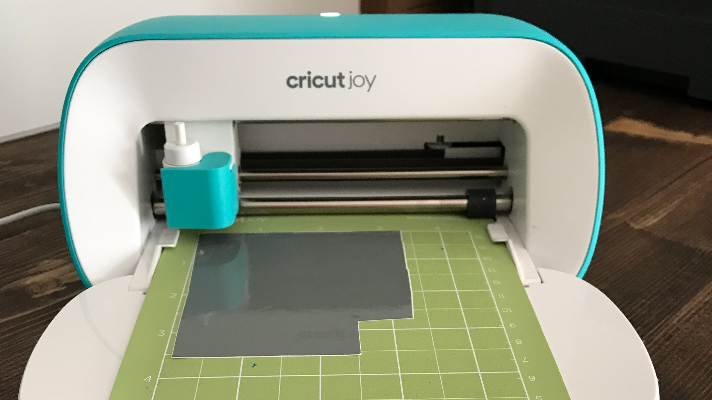 Cutting the vinyl and paper with the Cricut Joy to make a DIY elf camera ornament 