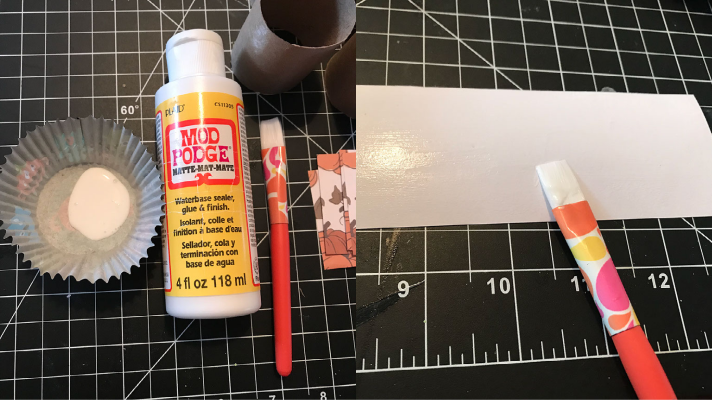 Using the Mod Podge to adhere the paper to the toilet paper roll