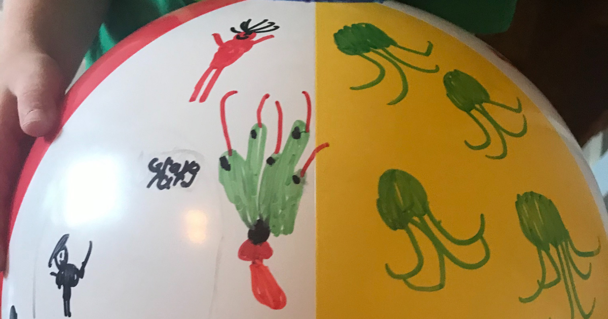 Drawings on beach ball with Sharpies for a fun summer school age activity